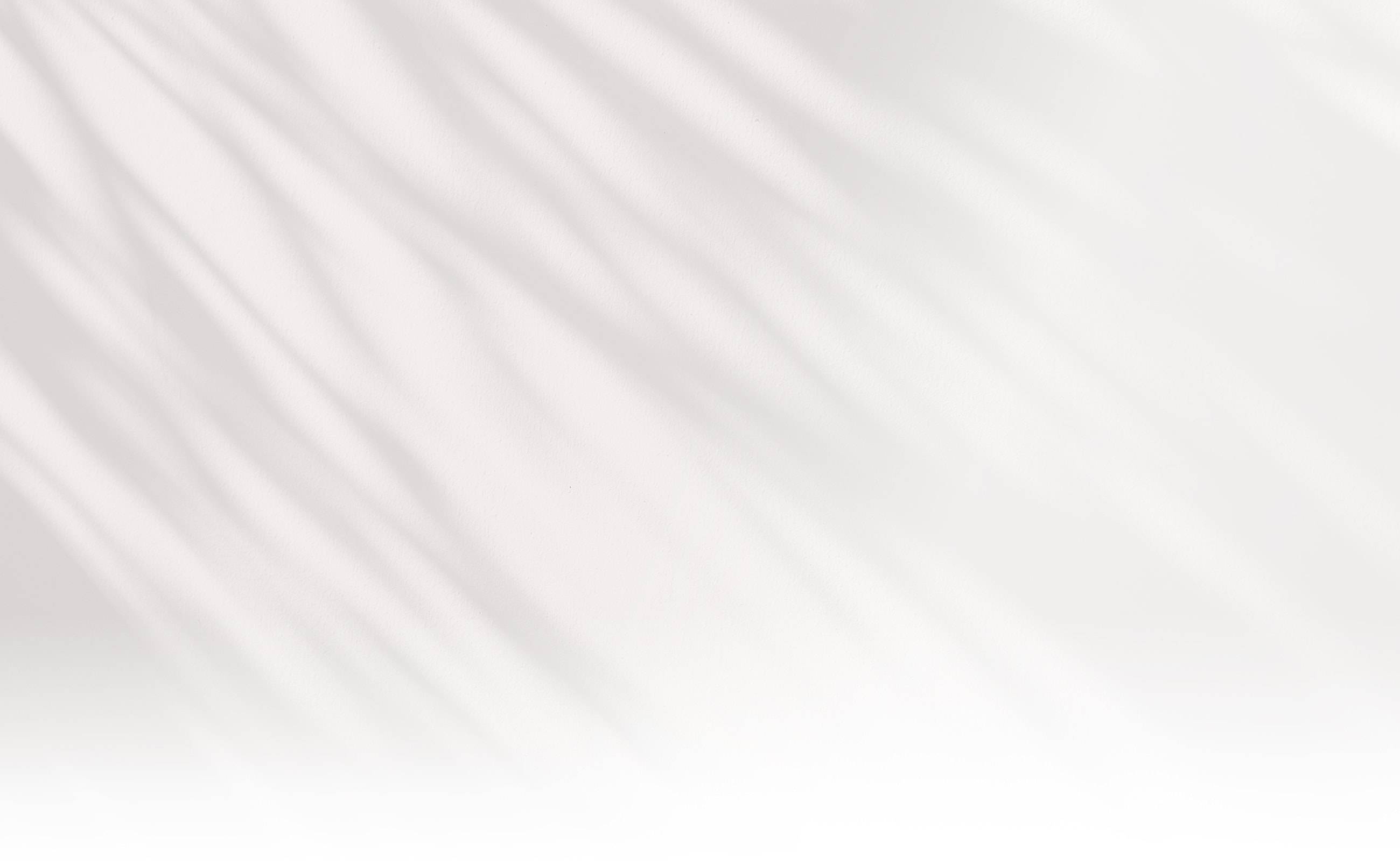 Soft white background with subtle textured shadows.