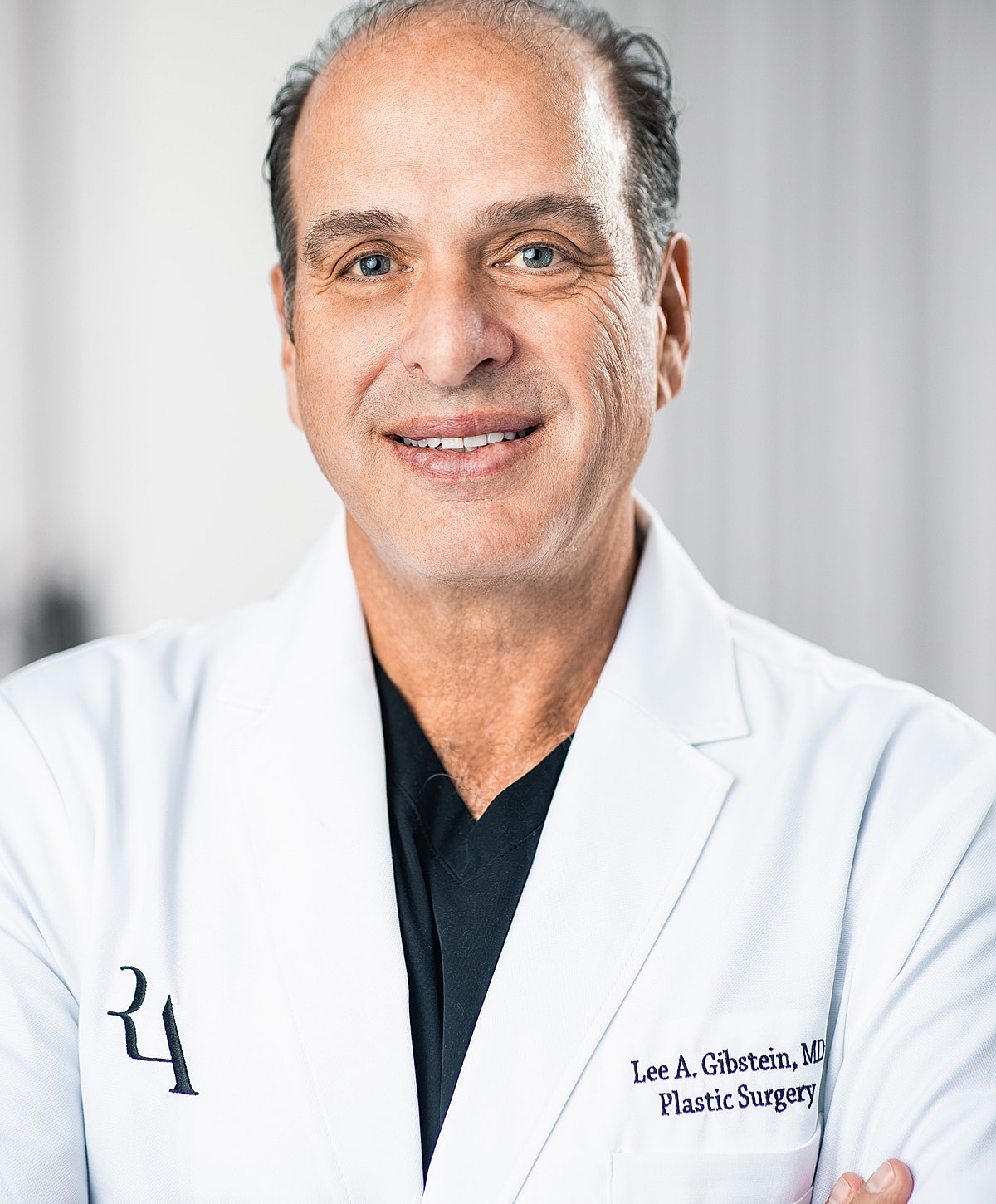 Doctor in white coat smiling for portrait.