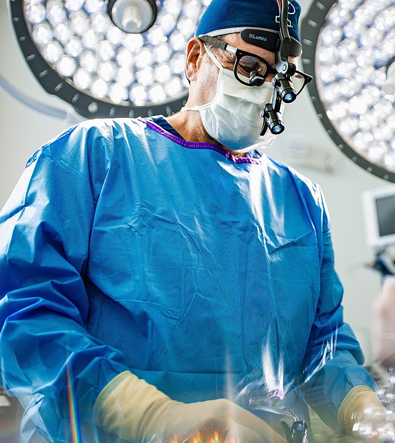 Surgeon performing surgery in operating room.