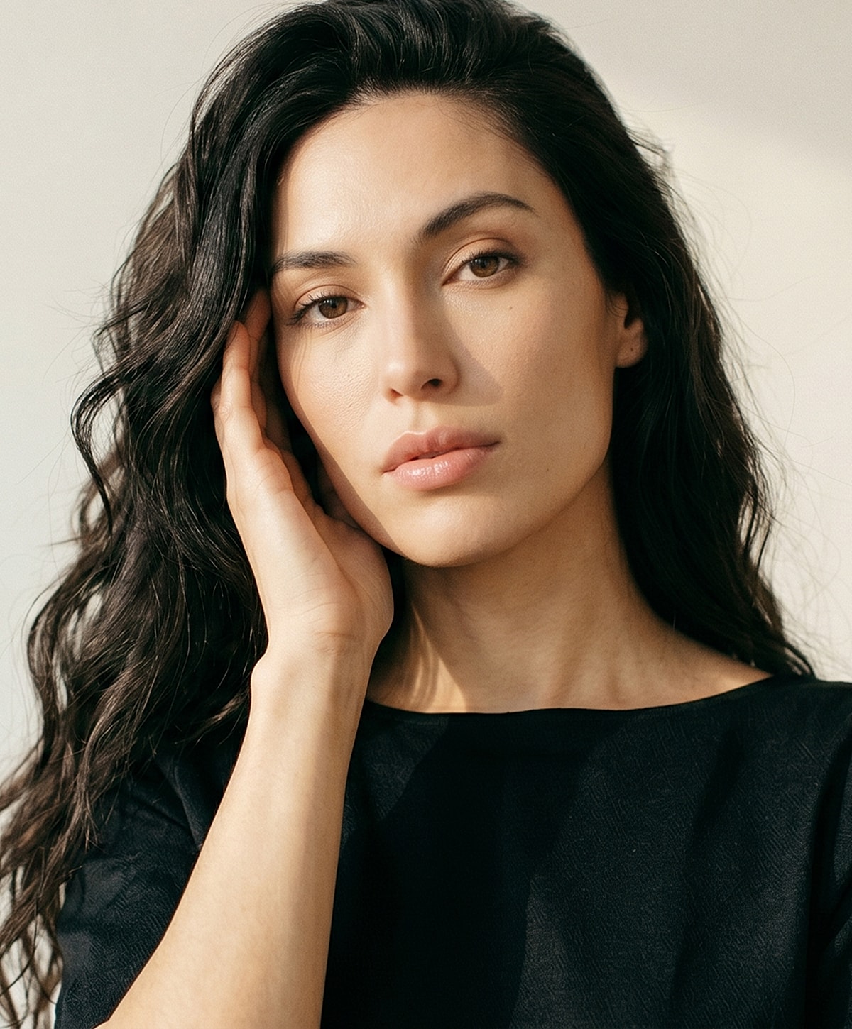 Woman with long, wavy hair in portrait.