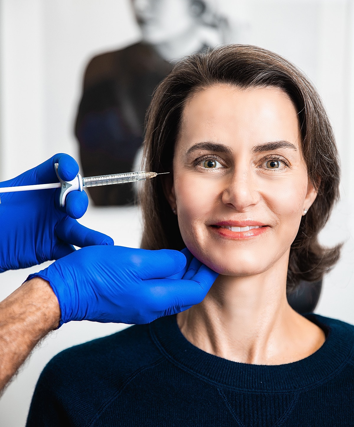 Woman receiving cosmetic injection treatment.