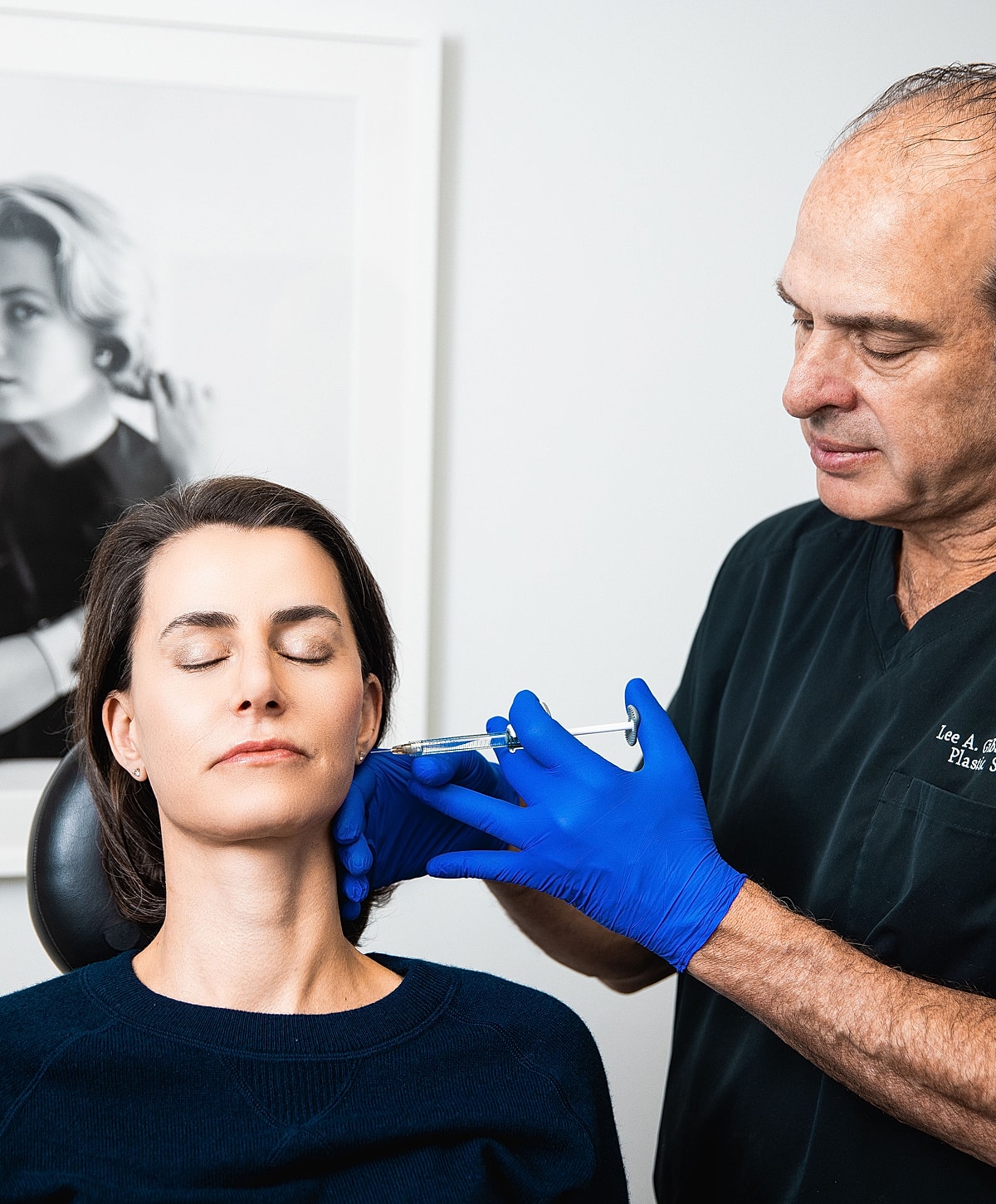 Patient receiving cosmetic treatment with syringe.