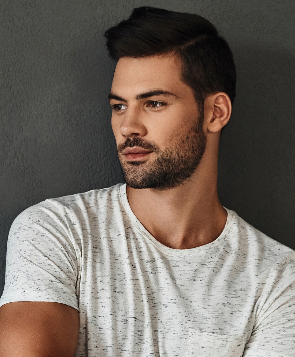 Man in casual shirt with thoughtful expression.