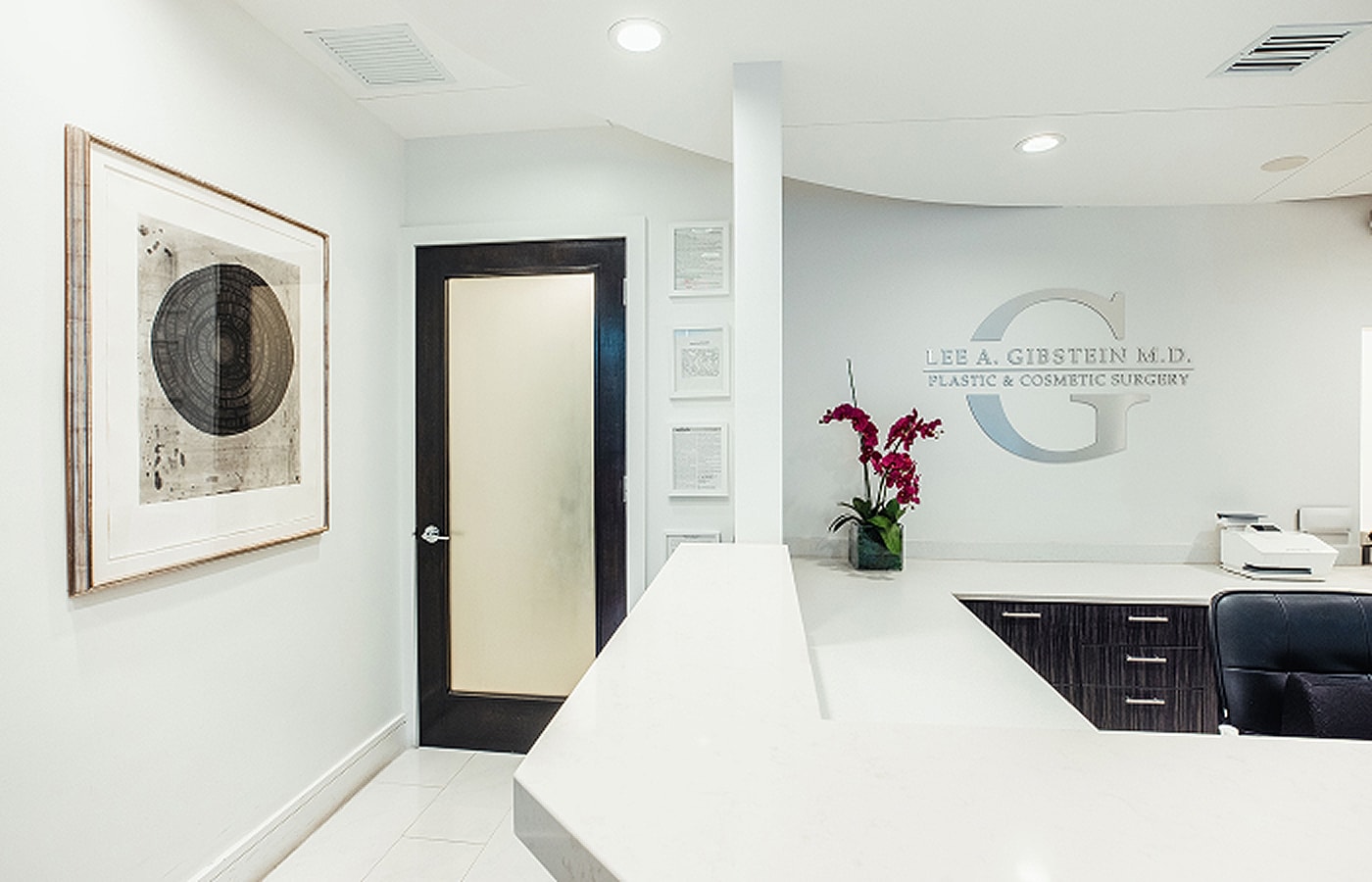Plastic surgery office reception area with art.