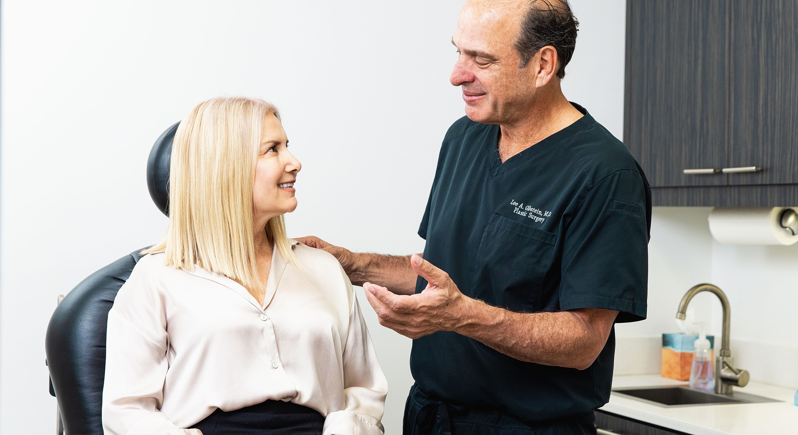 Doctor consulting with patient in clinic setting.