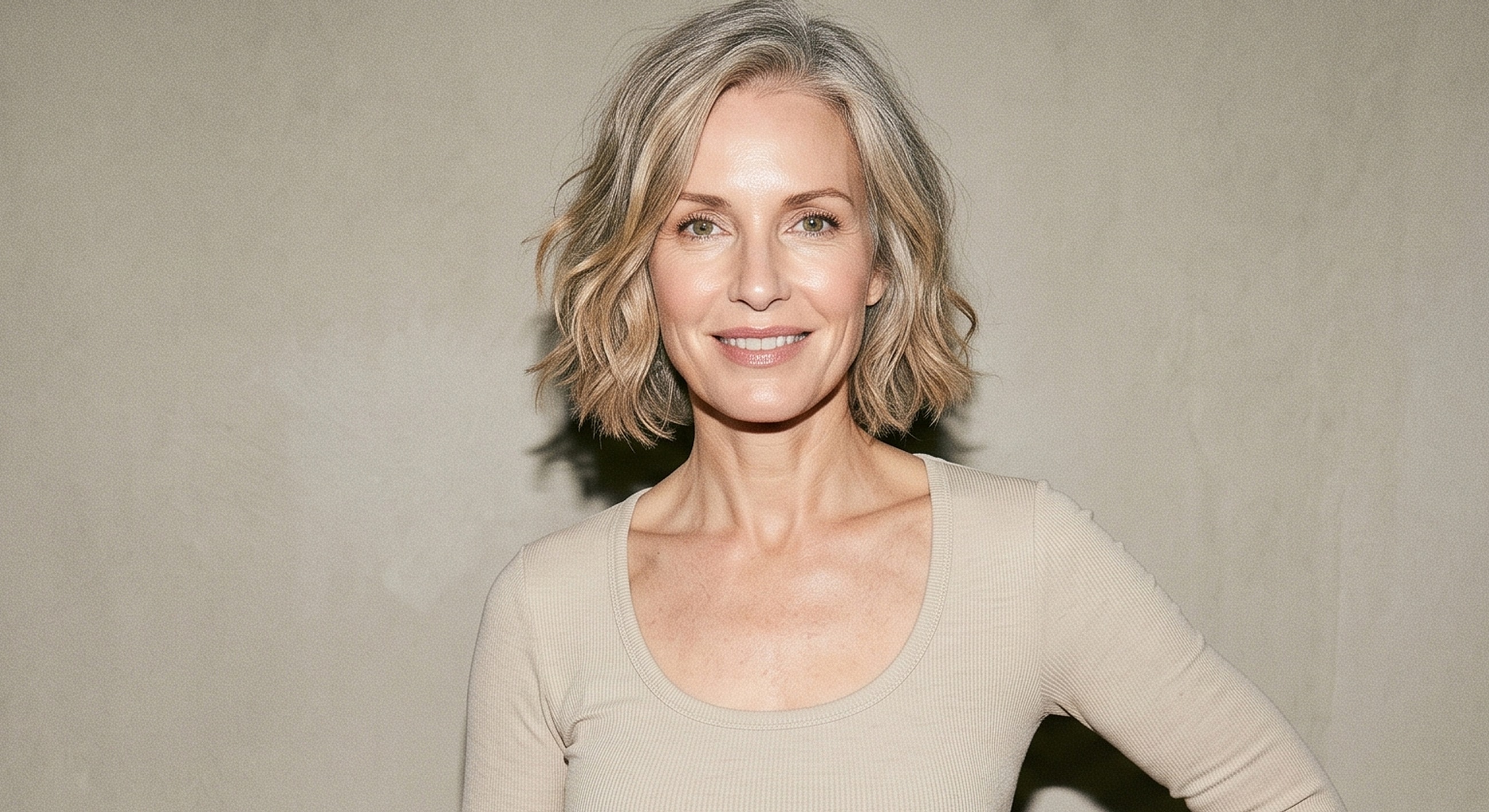 Smiling woman with short, wavy gray hair.