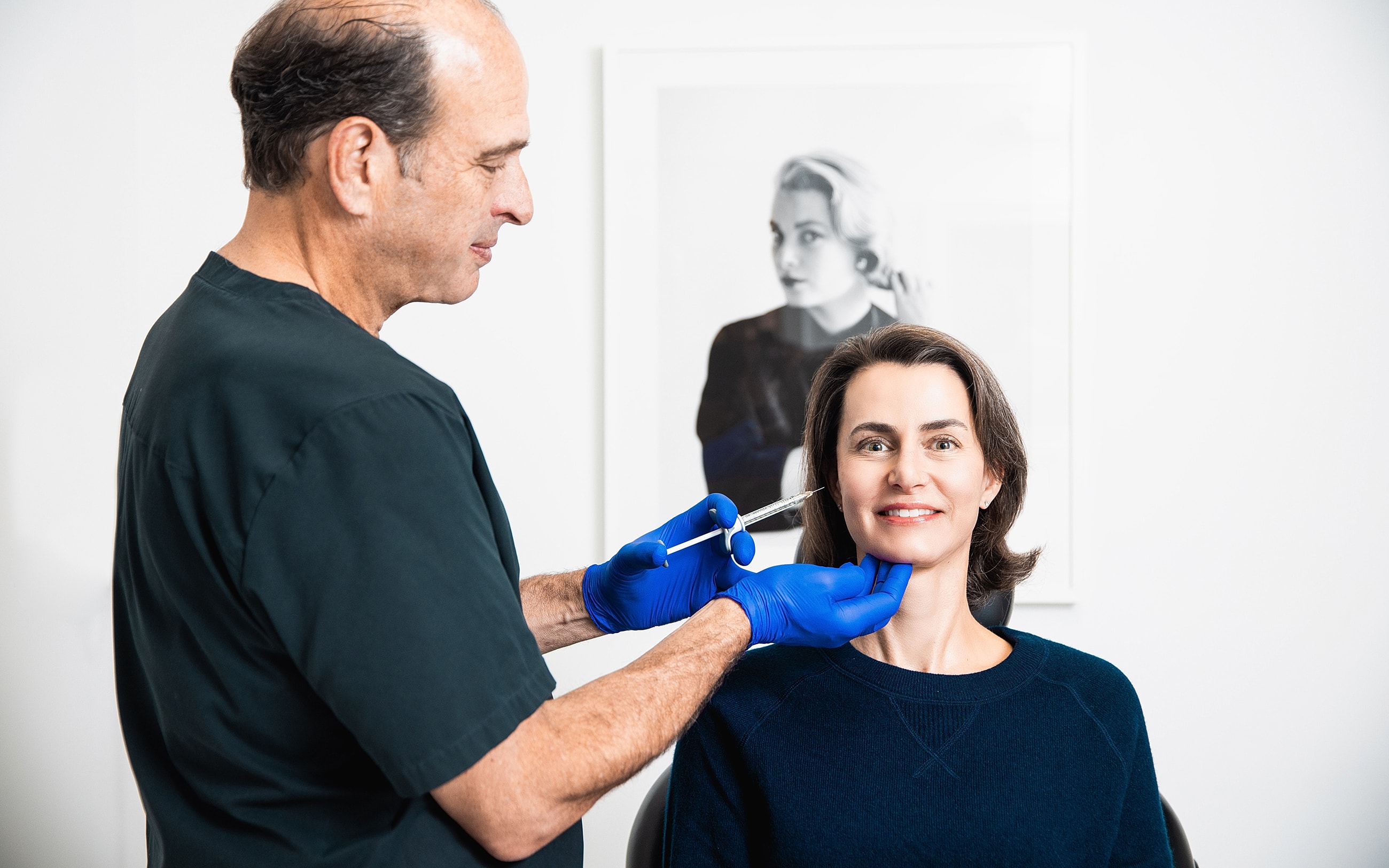 Medical professional demonstrating treatment on patient.